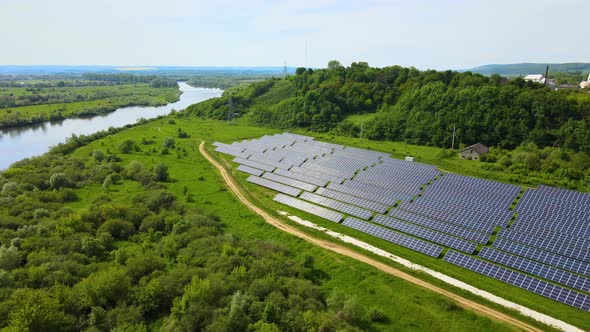 Aerial view of big sustainable electric power plant with many rows of solar photovoltaic panels