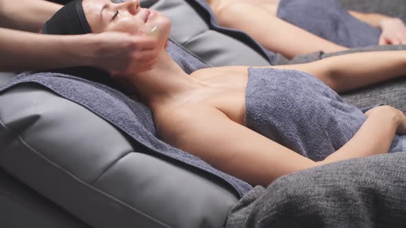 Young Women at the Spa Enjoy Facial and Cleavage Treatments