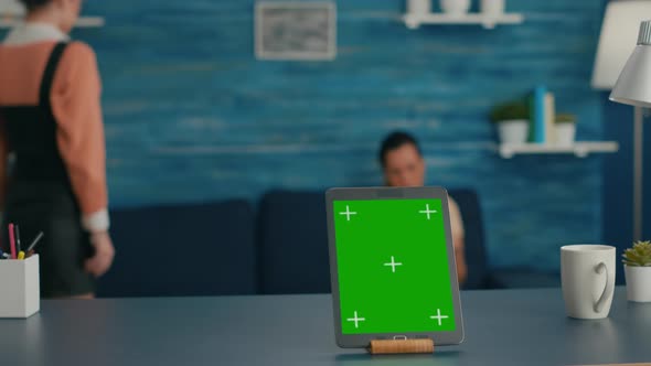 Isolated Tablet Computer with Mock Up Green Screen Chroma Key Standing on Desk Table