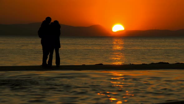 Young Couple Taking Selfie Near The Sea In Sunset