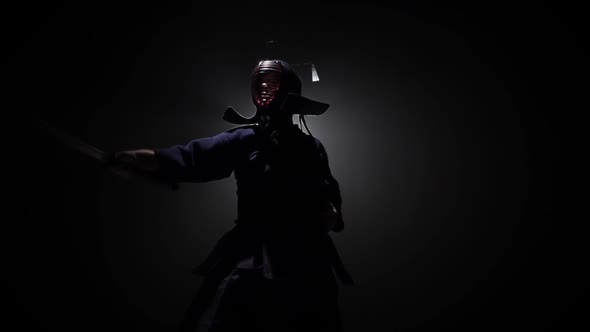 Kendo Warrior Is Practicing Martial Art with the Katana Sword. Slow Motion