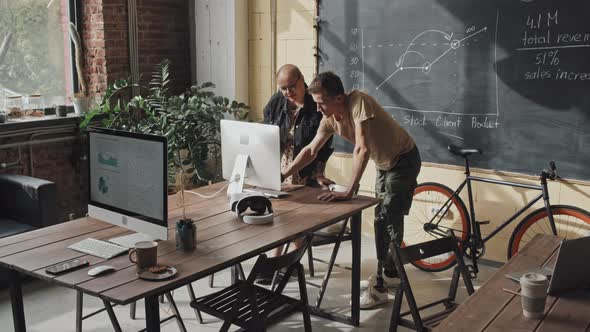 Two Workers Using Computer