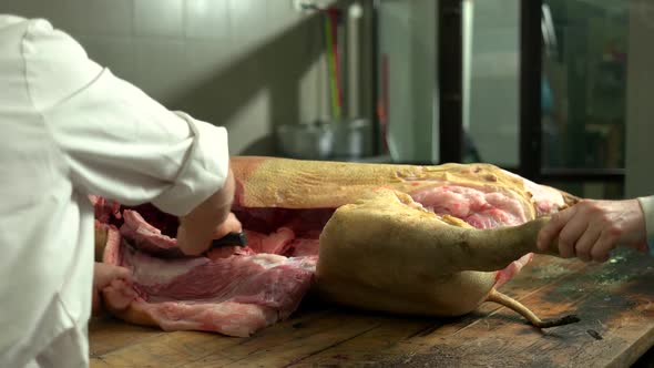 Butcher Cuts Pork Carcass