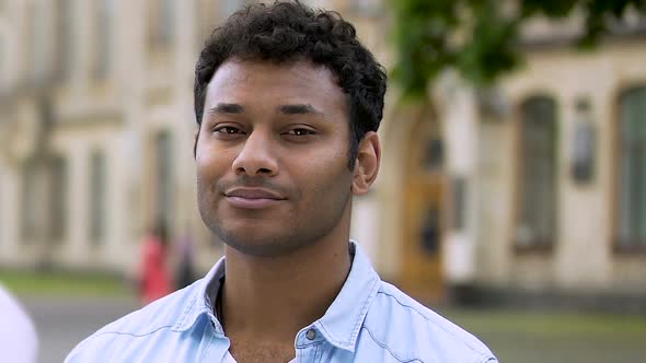 Happy male volunteer smiling into camera ready to help, no to indifference