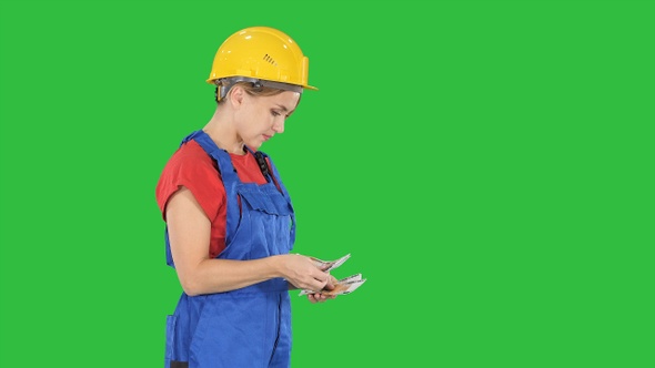 Young woman engineer or architect holding banknotes euros