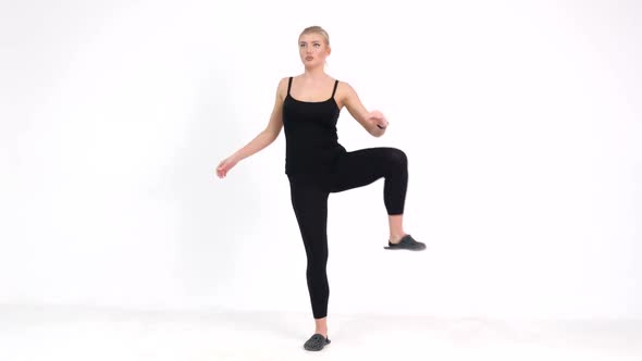 Slim Fit Fitness Girl Performs a Set of Exercises on a Gray Background