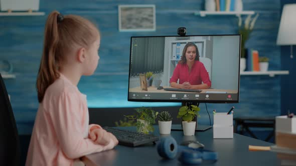 Little Girl Using Video Call for Online Remote Lesson with Teacher