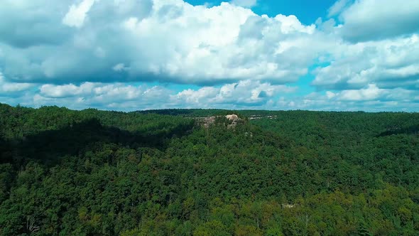 Flying North from Princess Arch toward a rock formation over a beautiful valley of trees.