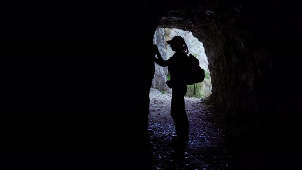 Girl in a Mine Knocks a Stone on the Wall