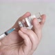 Doctor draws coronavirus vaccine into a syringe. - VideoHive Item for Sale