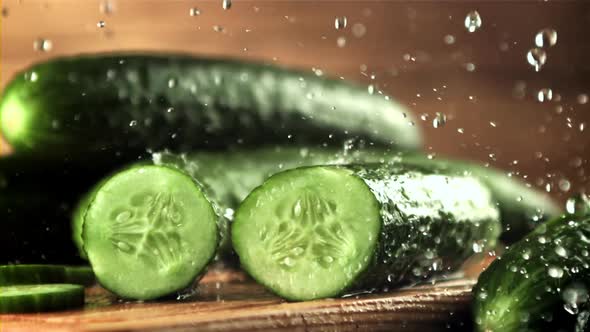 Drops of Water with Splashes Fall on Pieces of Fresh Cucumber