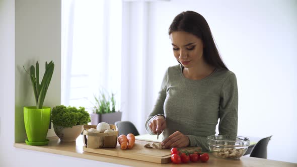 Healthy Food. Woman Cooking Fresh Vegetable Salad At Kitchen