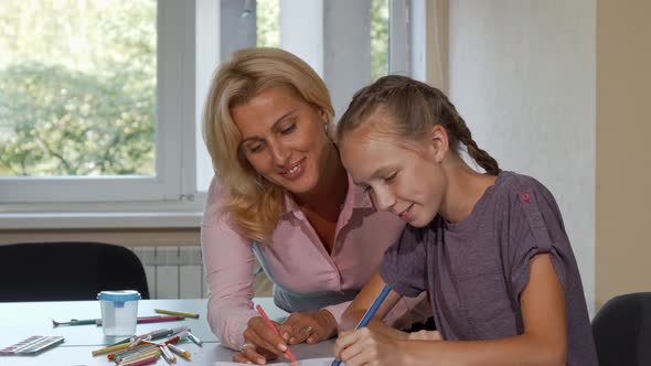 Mature Beautiful Woman Enjoying Drawing with Her Little Student