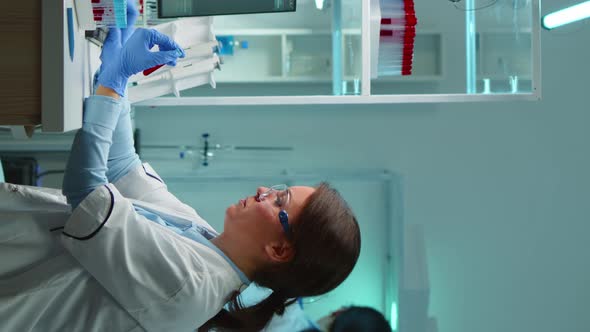 Vertical Video Medical Lab Worker Analyzing Blood Serum Conducting Virus Test