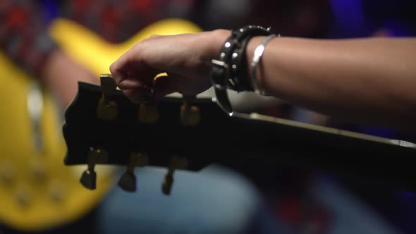 Unrecognizable Person Connecting Electric Guitar in Recording Studio