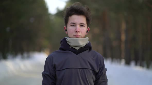 Portrait of Handsome Young Man in Headphones Ready To Run