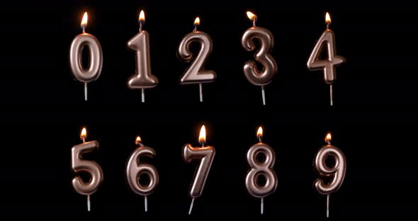 A set of Realistic full-sized birthday candle numbers isolated on black background. Fire is floating