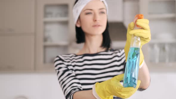 Woman Clean the Window with Rag and Spray