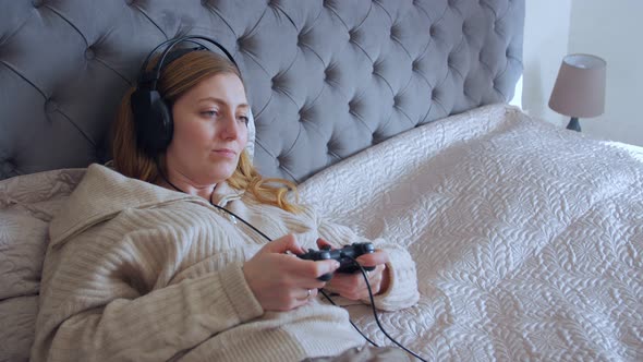 Woman Lying And Playing Video Games