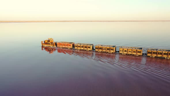 An Old Train Travels on a Railway Laid in the Water Across a Salt Lake