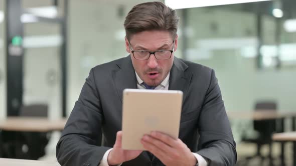 Middle Aged Businessman Having Loss on Tablet