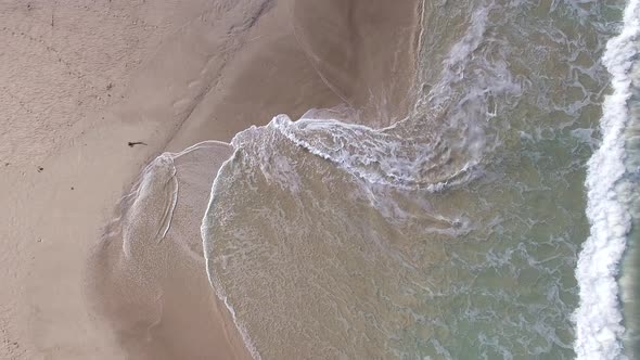 Aerial view of waves breaking on tropical beach, Lombok, Indonesia.