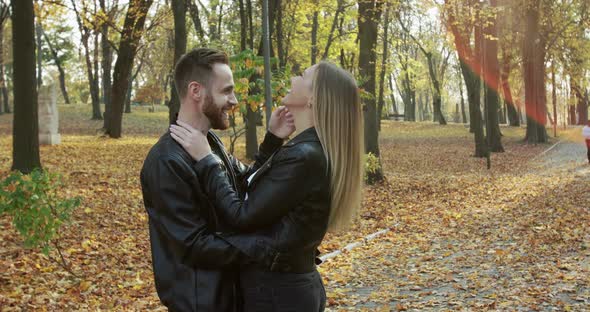 Lovely Couple Laughing and Having Fun While Standing in Embraces in Autumn Park