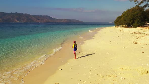 Guy fisherman on luxury island beach holiday by clear sea with white sand background of Gili Air nea