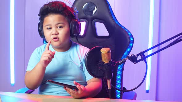 Asian Little Boy Holding Mobile Phone And Talking To Camera While Live Stream
