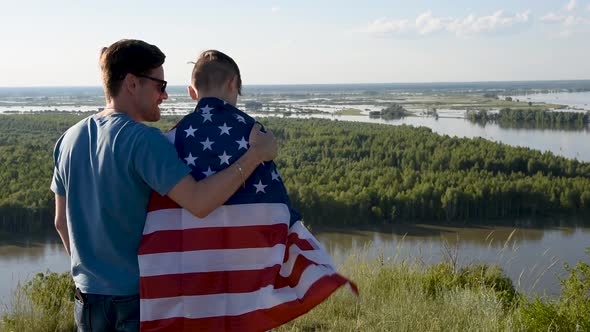 Cute Young Boy and His Father Holding Aloft the American Flag