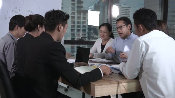 Asian Business People Discuss Marketing Strategy