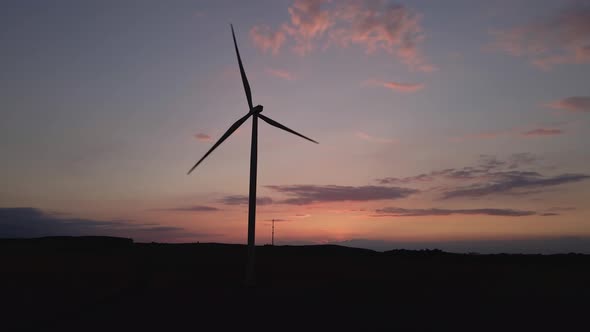 Silhouette of Windmill Turbine in Field at Sunset Sky