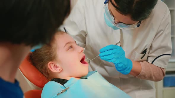 Close Up of Little Patient Lying on Chair with Open Mouth During Dental Examination