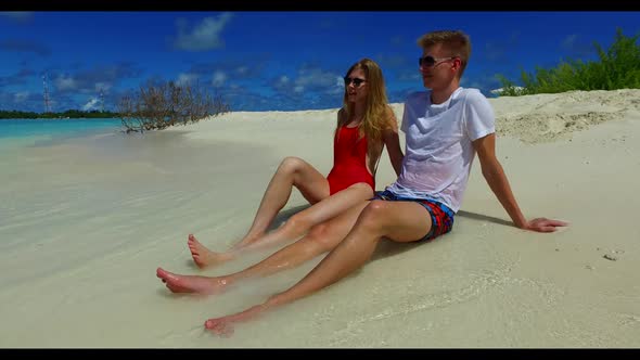 Romantic couple engaged on paradise coast beach holiday by blue sea and white sand background of the