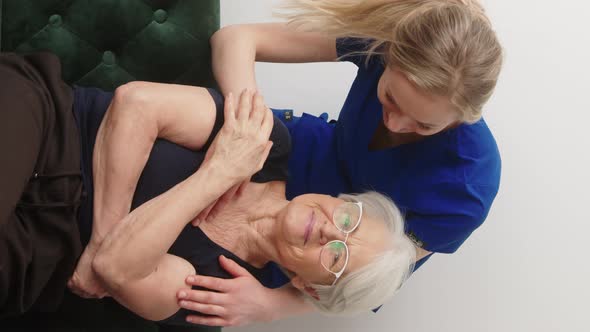 Vertical Video  Happy Cheerful Grandmother is Grateful for the Support of Young Nurse