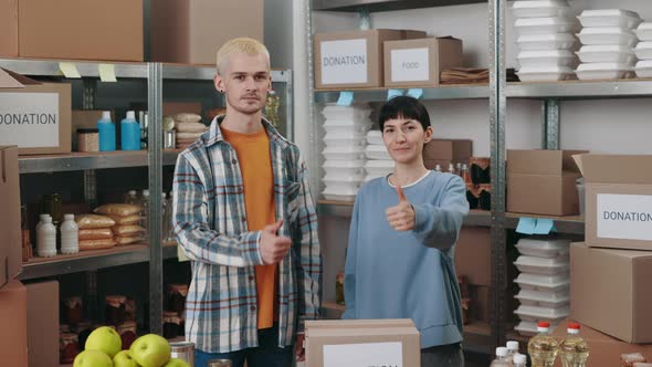 Team of Volunteers Gesturing Thumbs Up at Food Bank