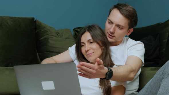 Happy Young Couple Using Laptop for Ecommerce Doing Online Shopping Together