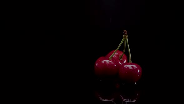 Cherry Slow Motion Closeup Falling in Water with Splash Droplets