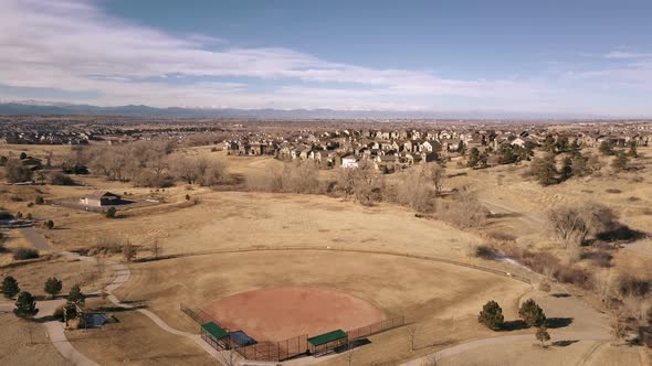 Aerial view of suburban open space park in snowless Winter