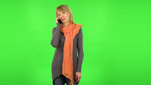 Middle Aged Blonde Woman Is Talking for Mobile Phone. Green Screen