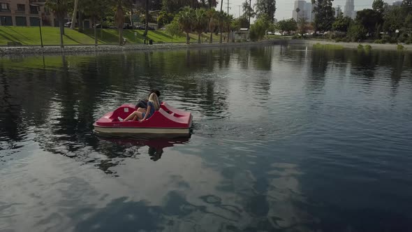 Cute Couple Enjoying A Boat Ride In The Park