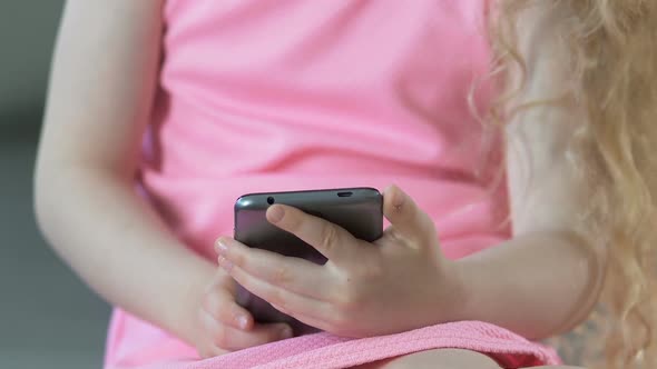 Female Kid Hands Playing on Mobile Phone