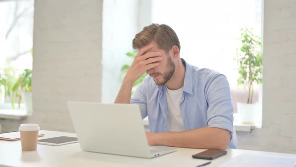 Young Creative Man with Laptop Having Loss Failure