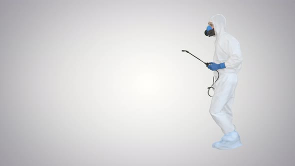 Man Wearing an NBC Personal Protective Equipment Spray Disinfectant and Dancing on Gradient