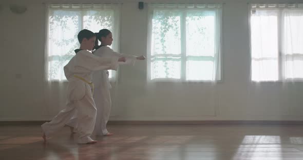 Slow motion footage of young kids practicing martial arts