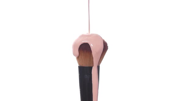 Beauty and Cosmetics Concept. Makeup Brush with Smeared Liquid Foundation