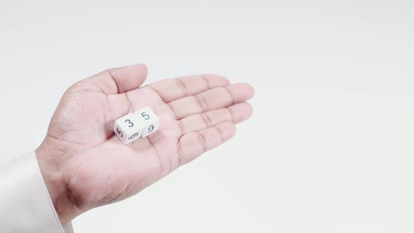 Hand Holds Numbered Dice   Three And Five Thirty Five