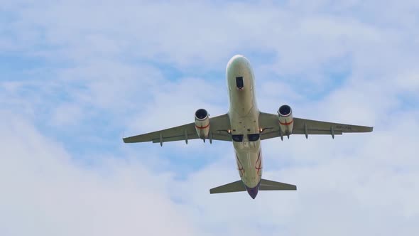 the plane takes off from the airport, picks up speed and height, flies over the camera