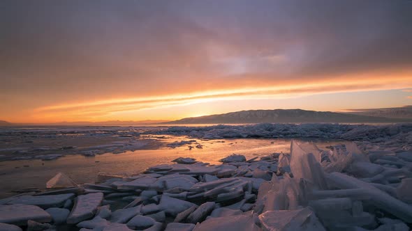 Time lapse over ice stacks during beautiful winter sunset at Utah Lake