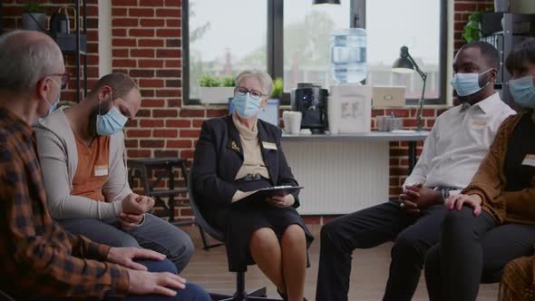 Old Person with Face Mask Sharing Addiction Problems with Therapist and People at Aa Therapy Session